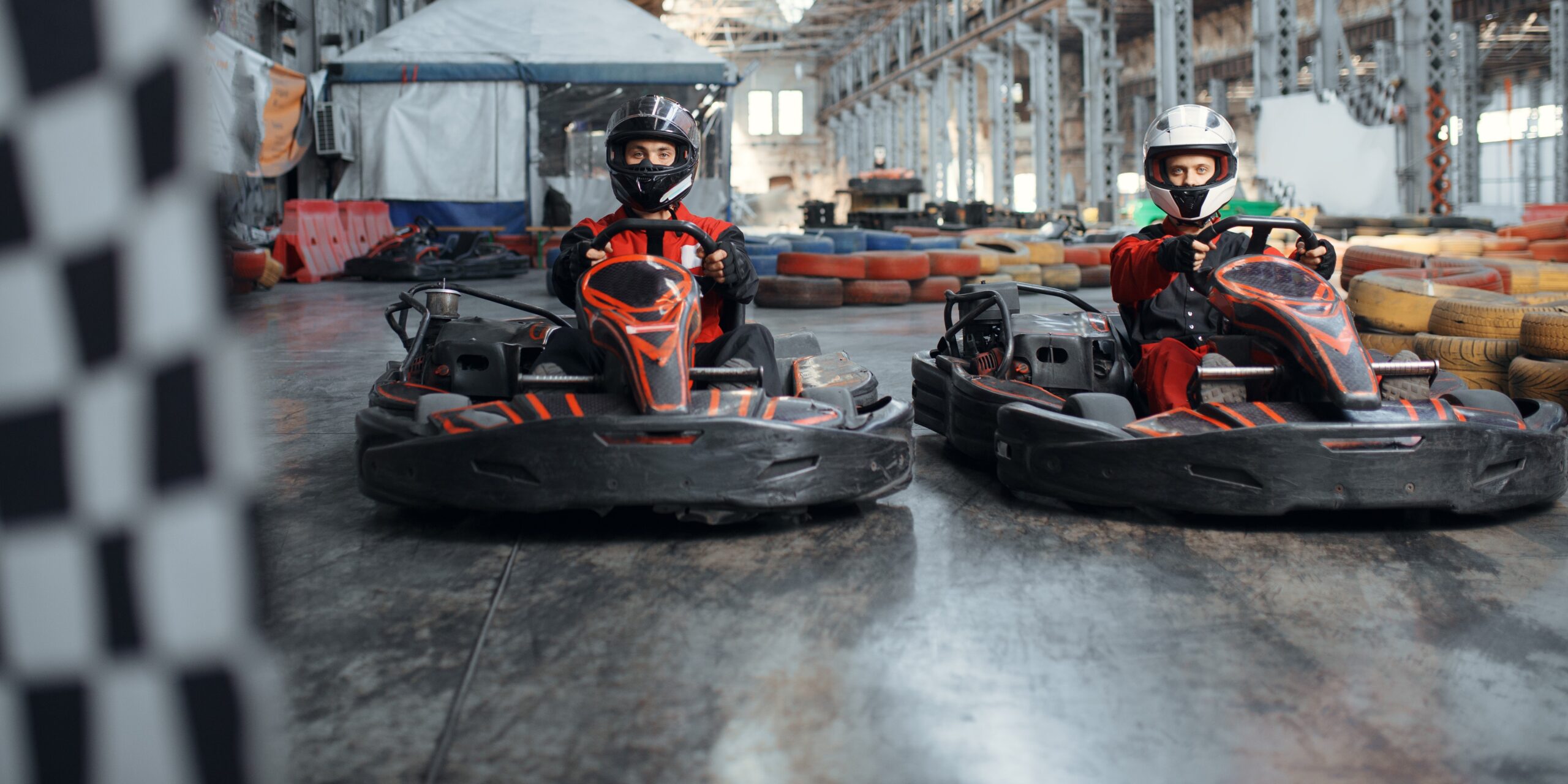 two kart racers on start line checkered flag